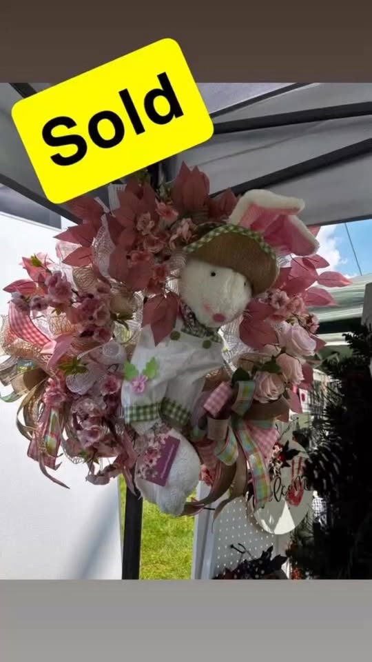 My bunny wreath hanging at the market booth with a big yellow SOLD sticker on it.